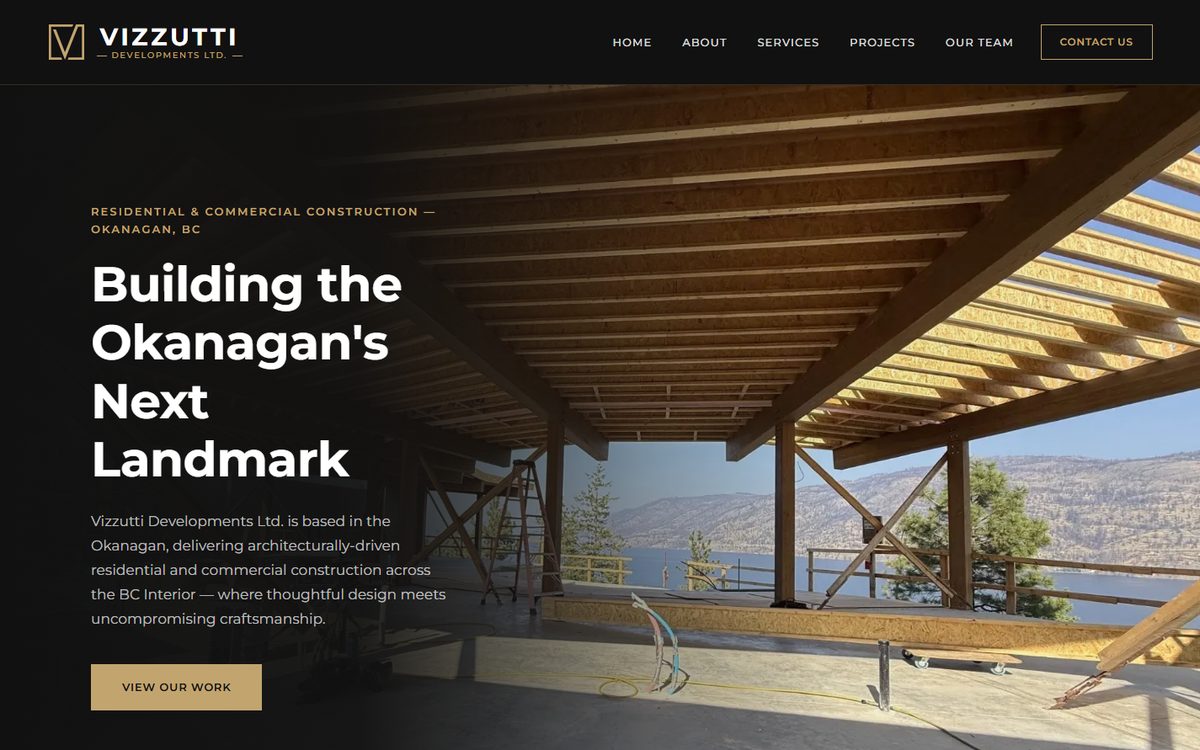 The home page of the Vizzutti Developments website, showing a timber-framed building under construction beside a lake.